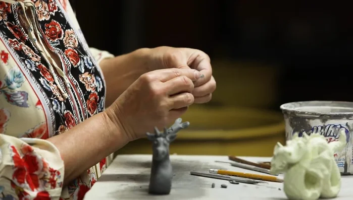 Create flippers/wings by pinching, shaping, and texturing small amounts of clay, then scoring and slipping them onto the body.