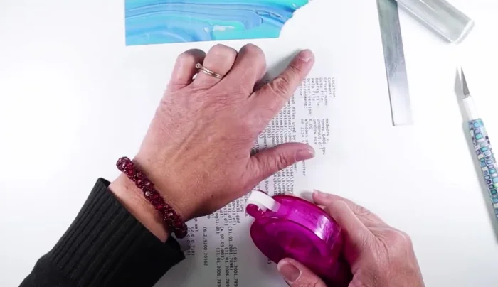 Wrap the clay sheet tightly around a wooden dowel or acrylic rod. Secure the edge with adhesive, ensuring it adheres completely to the previous layer.