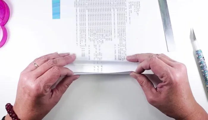 Wrap the clay sheet tightly around a wooden dowel or acrylic rod. Secure the edge with adhesive, ensuring it adheres completely to the previous layer.