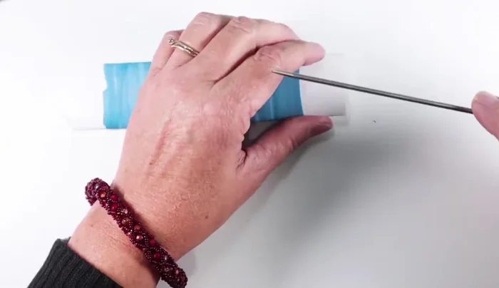 After baking, remove the paper carefully, using a tool such as a knitting needle to loosen it as needed. If the paper is stuck, carefully remove it with pliers, gripping only the paper.