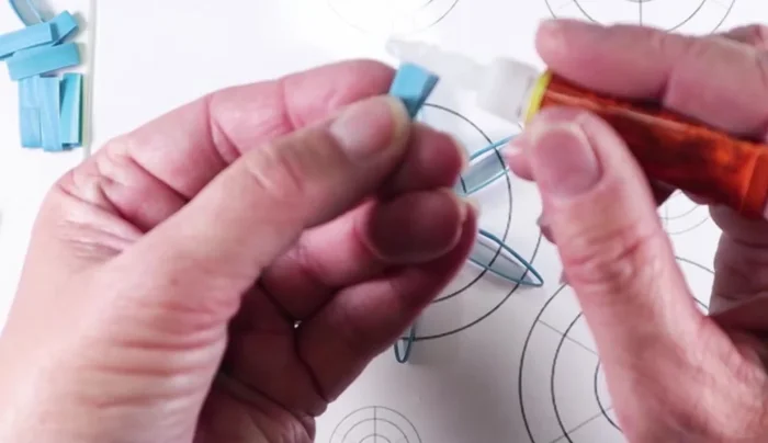 Cut and glue small v-shaped pieces to the ends of the interior loops, for further embellishment, optional.