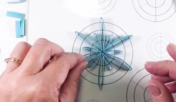 Cut and glue small v-shaped pieces to the ends of the interior loops, for further embellishment, optional.