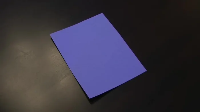 Cut off the top of the cone, ensuring it fits the top of your bottle. Measure to ensure it's the right size before cutting.