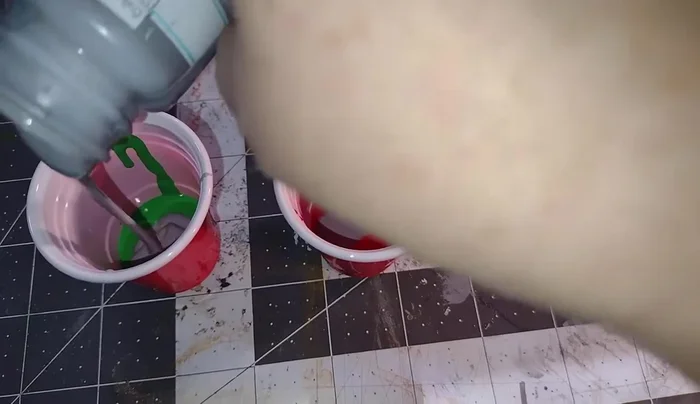 Apply a thin coat of red paint to the second dollhouse.