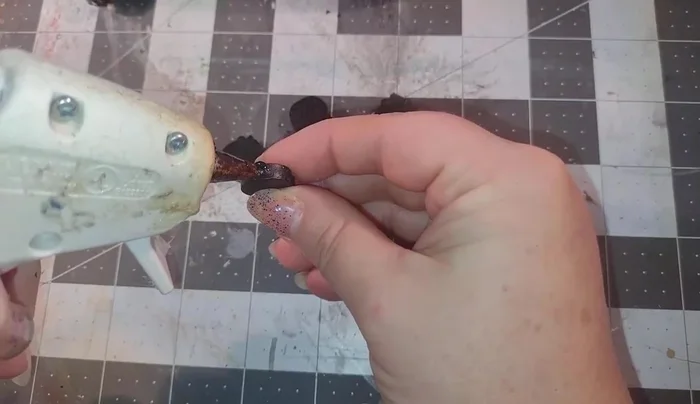 Add the popsicle sticks and skull cupcake picks to the dollhouses as details.