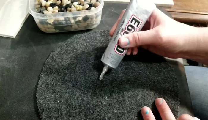 Place rocks onto the glued areas, pressing firmly to ensure adhesion. Arrange rocks to create a desired pattern or design. Aim for roughly the same size rocks for even coverage.