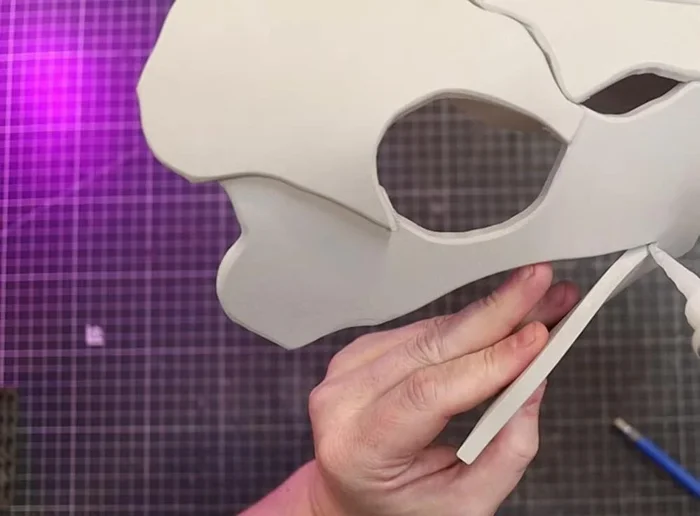 Glue Part D to the underside of Part A and inside of the skull.