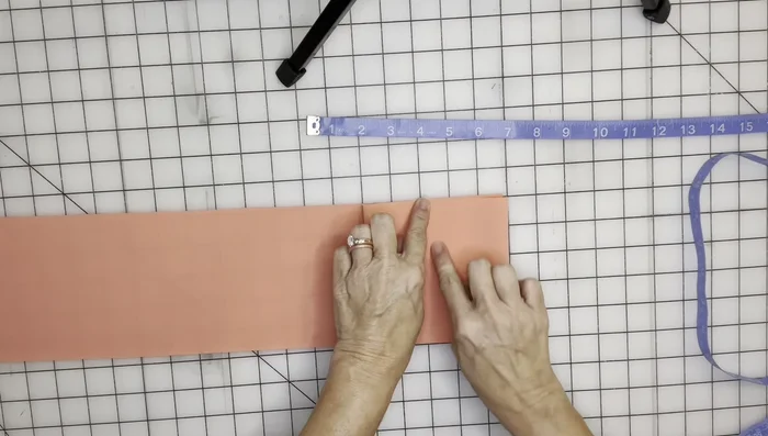 Use your fingers to hold the bow in place while pulling the fabric tight to create a bow shape. Fold the raw ends in neatly.