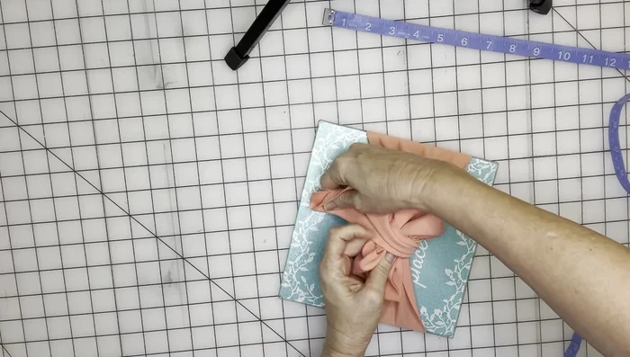 Trim the excess fabric and secure the ends with glue or stitches.