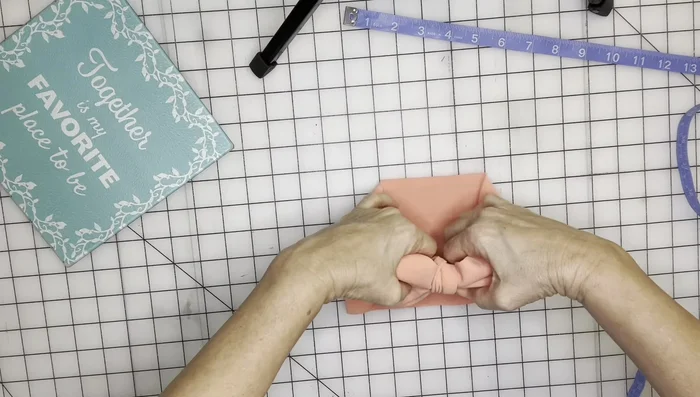 Trim the excess fabric and secure the ends with glue or stitches.