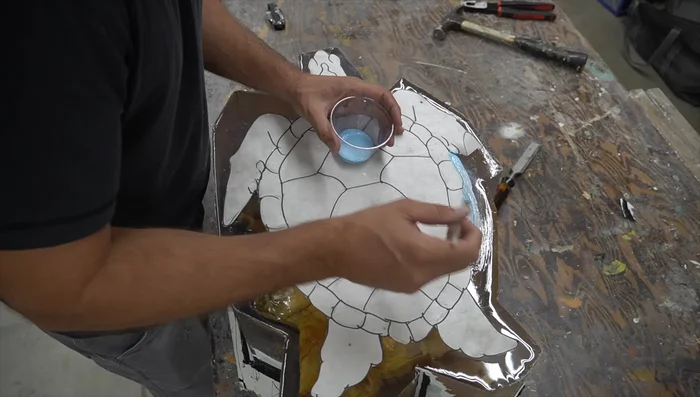 Carving: Use a 3D model as a guide. Start with rough shaping using a chainsaw, then refine with an angle grinder, and finally, sand to 5000 grit.