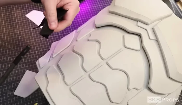 Cut two Part P pieces from 6mm foam, sandwiching nylon straps for back support. Secure straps with hot glue, super glue, and parachute clips.