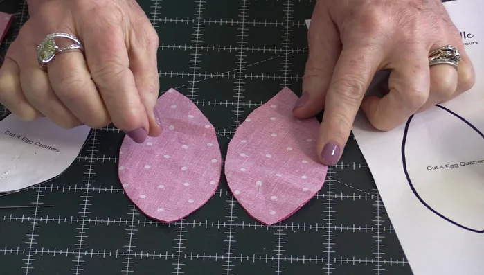 Sew two pairs of egg shapes together using a quarter-inch seam allowance. Trim seams.
