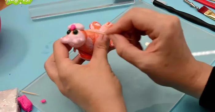 Add details: Use a toothpick to create fur texture lines on the cat's head. Add a touch of pink to the inside of the ears.