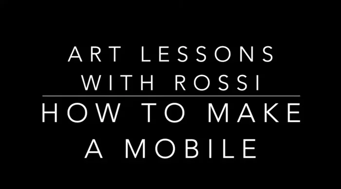 Find the balance point of the wire connecting the two cardstock pieces. Crimp the wire at this point to create a loop.
