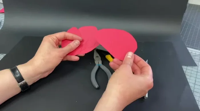 Prepare cardstock shapes resembling Calder's work. Cut them into small, organic shapes.