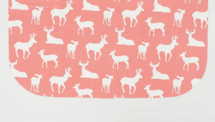 Attach pocket to apron: Place the pocket (right side up) onto the apron (right side up), matching the pocket's top edge with the marked placement line on the apron. Baste the pocket to the apron along the bottom edge.