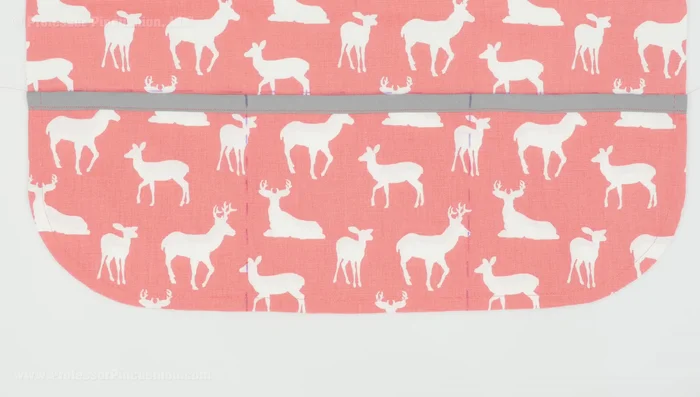 Create divided pockets (optional): Stitch along the marked pocket stitch lines to create three individual pockets instead of one large pocket.