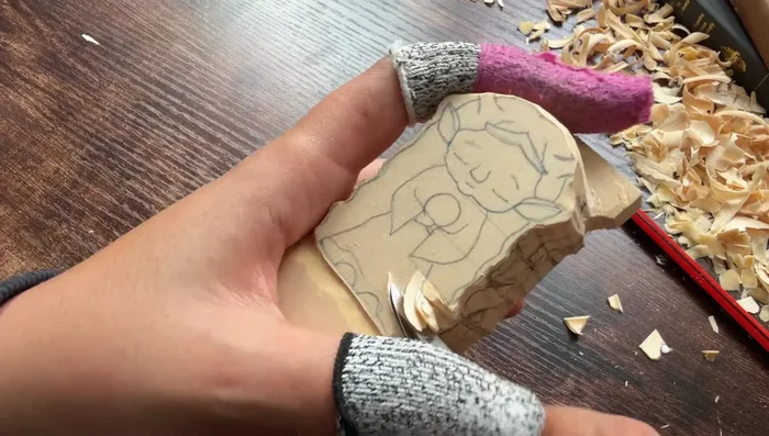 Carve the skirt and forearm portions, removing excess wood and shaping.