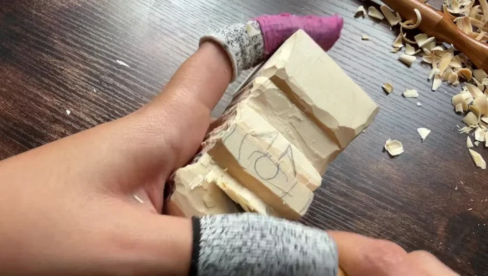 Refine the overall shape, removing excess wood and paying attention to detail.