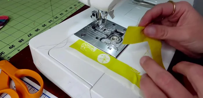 Piece together scraps of fabric to create one side of the star ornament. Sew with a 1/4 inch seam allowance. Press seams open.