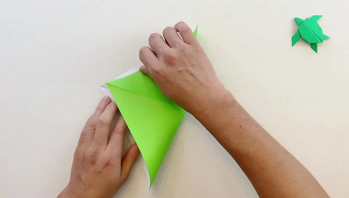 Fold diagonally in both directions.