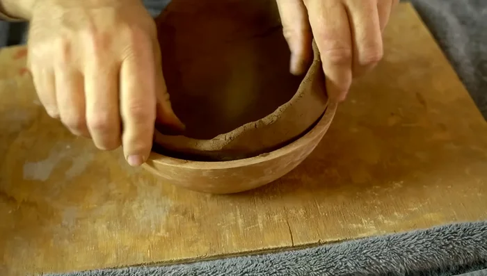 Use a wet gourd rib to smooth the inside of the pot.