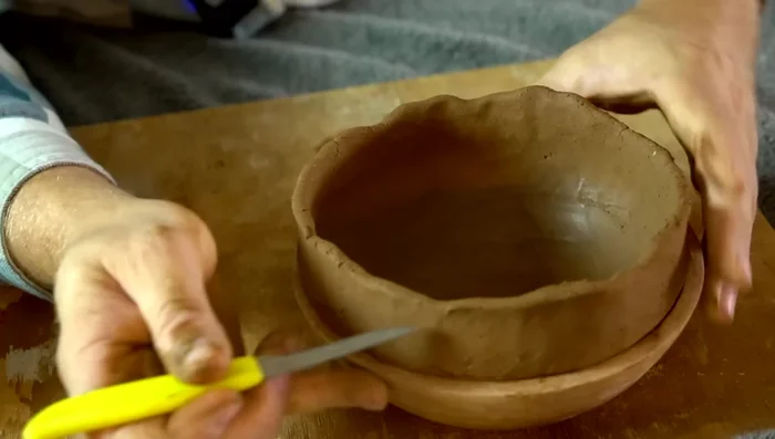 Dampen the rim and shape it with wet fingers.