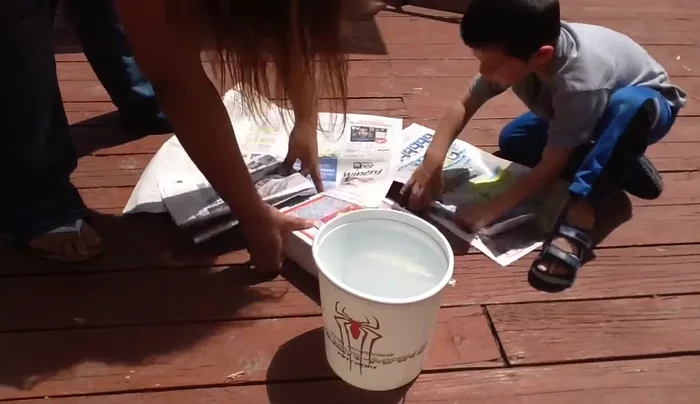 Prepare your workspace by laying down newspapers.