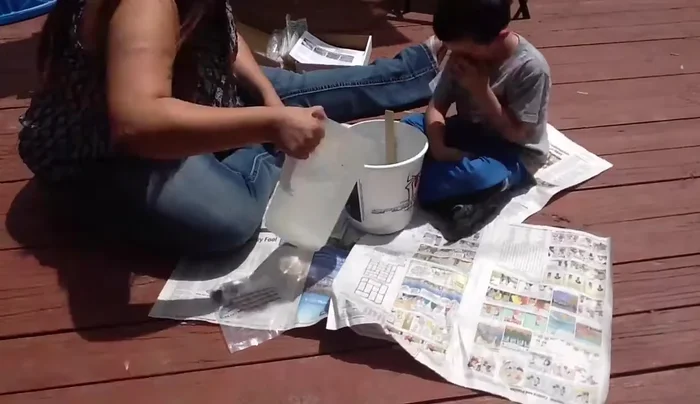 Mix the concrete according to the kit's instructions. Add water gradually until you reach the right consistency. Keep children away from the concrete dust.