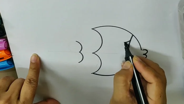 Connect the top points of the 'D' shapes with a curved line to form the fish's body.
