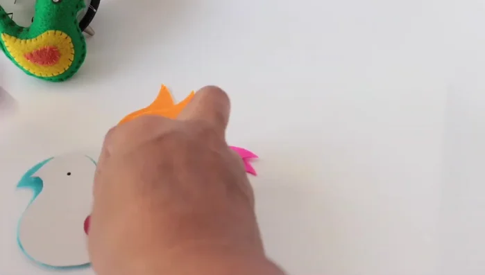 Embroider eyes onto the felt bird head pieces.