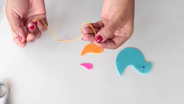 Attach the smaller feather pieces to the larger ones using an overcast stitch.