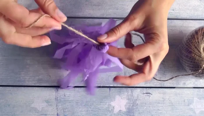 Attach tassels to the pack thread using glue.