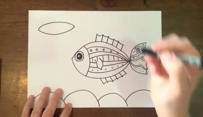 Draw a third fish: a different shape, adding variety to the scene.