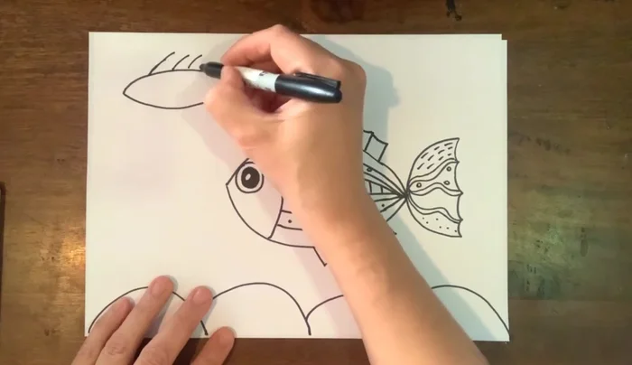 Add details to the second fish: face, eye, and patterns on the body and tail.