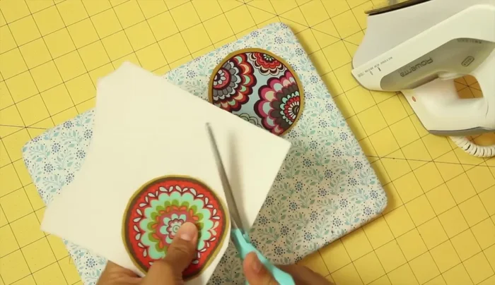 Cut out one piece of interfacing using your fabric circles as templates.