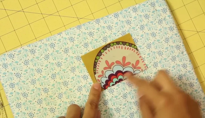 Position the loop on the fused circle, leaving 1/2 to 3/4 inch extending beyond the edge. Fuse in place.