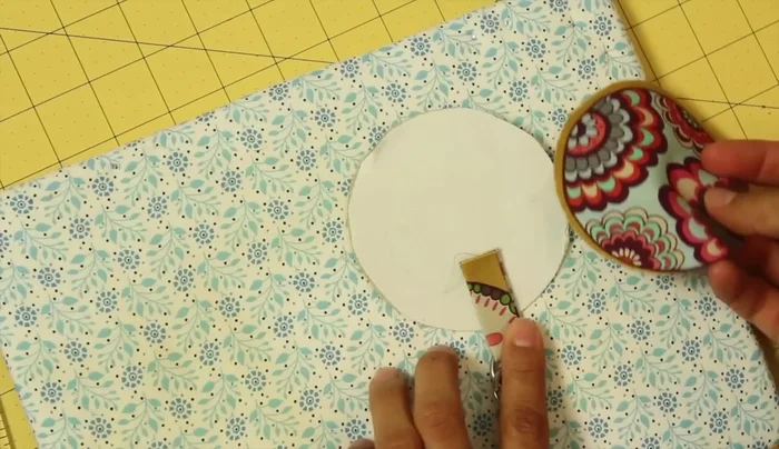 Position the loop on the fused circle, leaving 1/2 to 3/4 inch extending beyond the edge. Fuse in place.