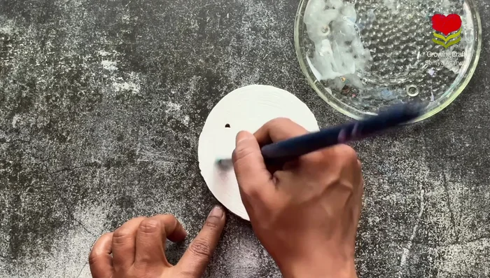 Stick the rice paper onto the prepared coaster base.