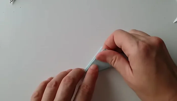 Fold the left side triangle to the other side again.