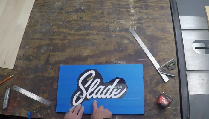 Use a router (Flying Dutchman Ultra Reverse UR7) to cut out the name from the stencil.