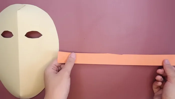 Decorate the mask. Cut strips of colored paper for hair. You can curl them using a pencil.