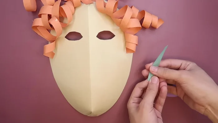 Glue the mouth in place. Add designs, details, sequins, or glitter as desired.