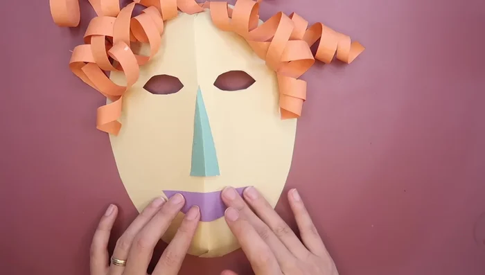 Glue the mouth in place. Add designs, details, sequins, or glitter as desired.