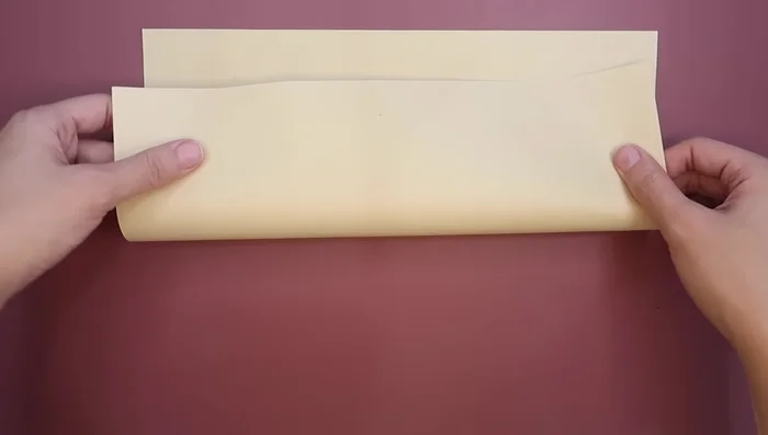 Draw and cut lines at the top and bottom of the paper (about one inch long) to create tabs for gluing.