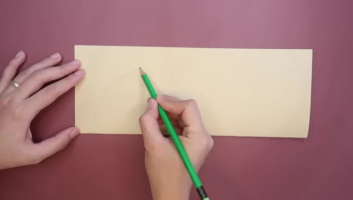 Draw and cut lines at the top and bottom of the paper (about one inch long) to create tabs for gluing.