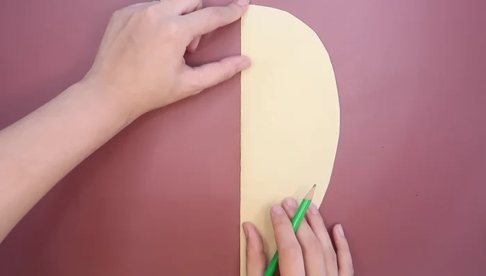 Draw and cut lines at the top and bottom of the paper (about one inch long) to create tabs for gluing.