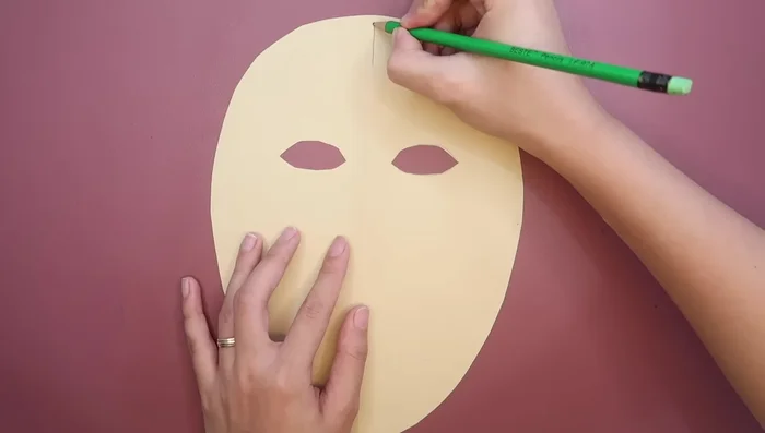 Draw and cut lines at the top and bottom of the paper (about one inch long) to create tabs for gluing.