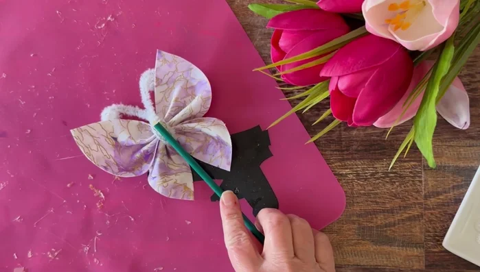 For floral picks: Add hot glue to the base of the butterfly and attach it to a floral stick or bamboo skewer. Cover the stick with floral tape if desired.